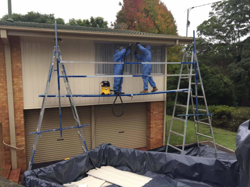 Rapid asbestos removal team at work on residential real estate job.