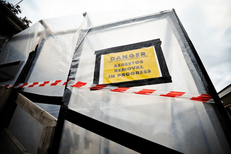 Danger Asbestos Removal in Progress sign. commercial asbestos removal