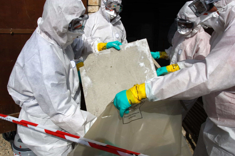 Image of people removing asbestos. removal of asbestos