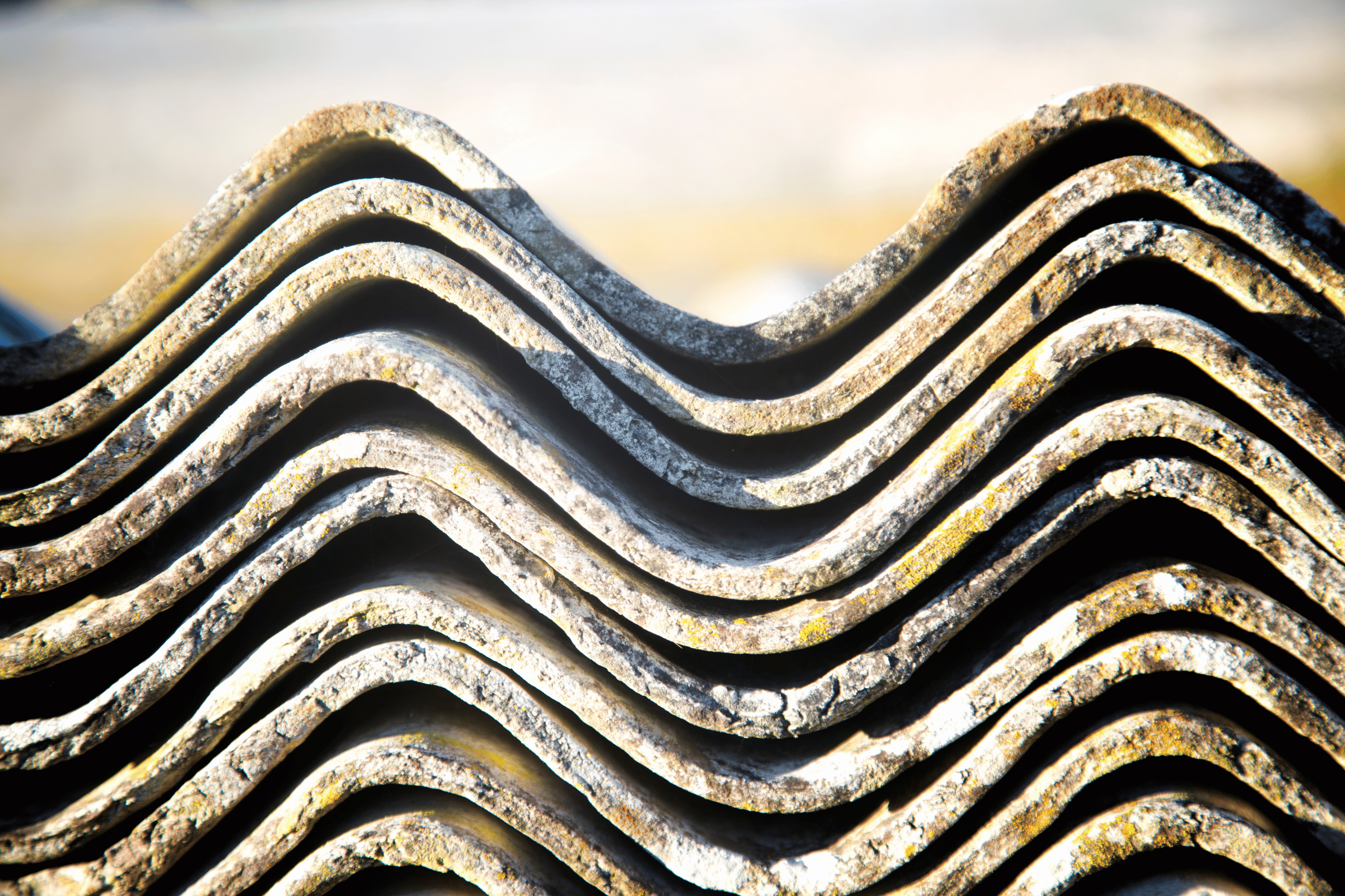 Pile of asbestos cement sheeting, neatly stacked on top of one another. asbestos cement sheet