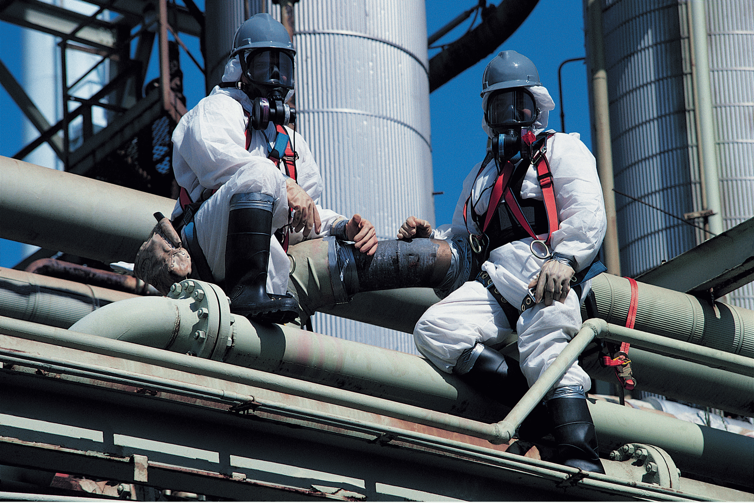 Two asbestos inspectors removing asbestos from a building. asbestos roof removal