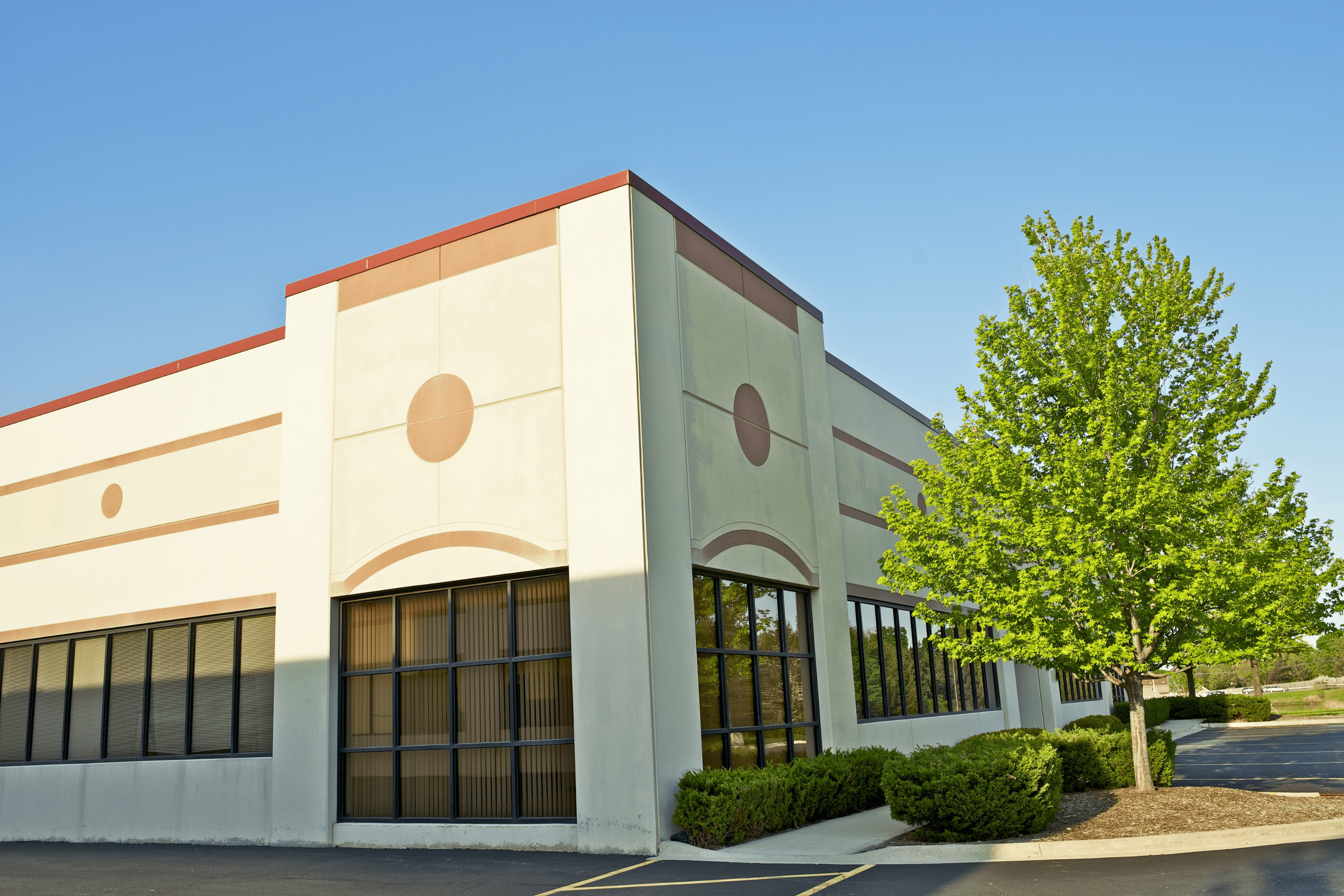 Two story, white work building.