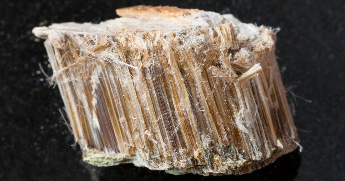 Types of Asbestos Found in Perth Households 2 Brown asbestos mineral on dark background. asbestos in houses