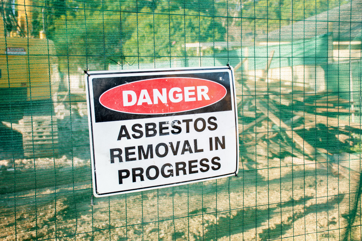 Unearthing Danger: The Hidden Risks of Asbestos in Soil 1 Danger Asbestos Removal in Progress sign on site. asbestos services