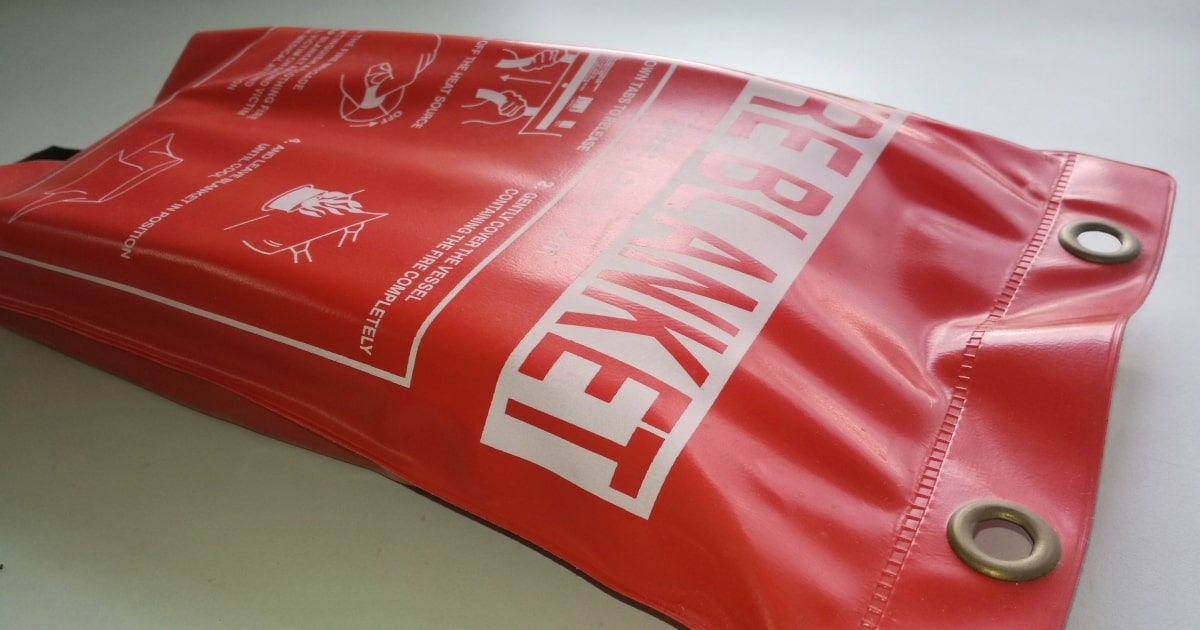 A red fire blanket that illustrates products that may contain asbestos.