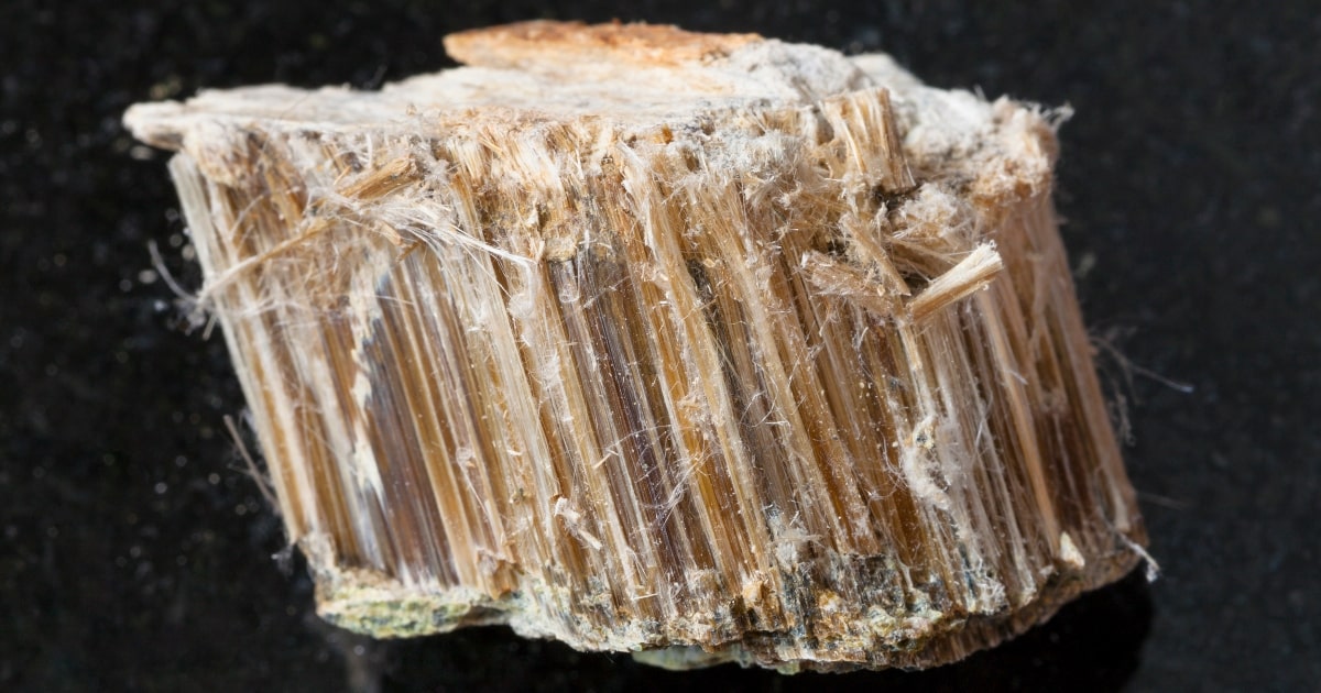 Brown types of asbestos minerals on dark background.